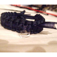 Paracord Bracelet Shown in Black with Charms shown in purple